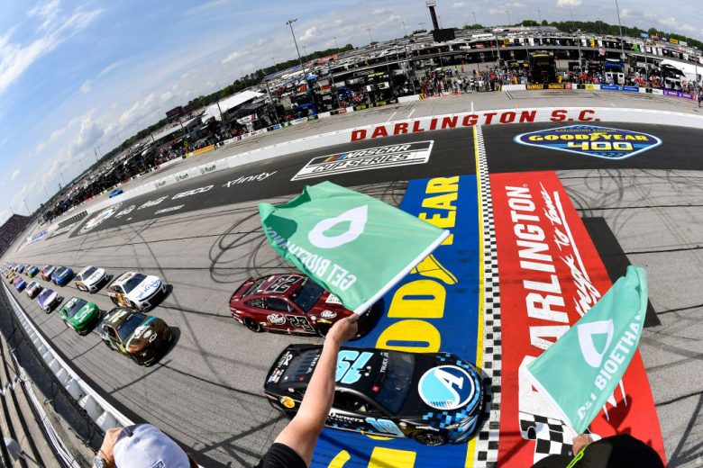 NASCAR Cup Series cars drive under the green flag at Darlington Raceway.