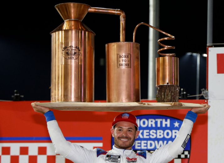 Kyle Larson poses with trophy