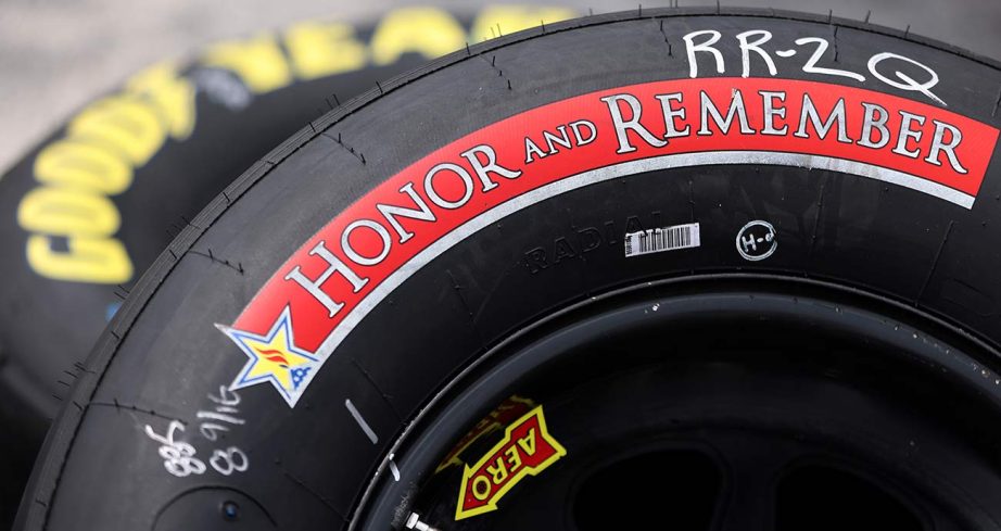 The Honor and Remember logo adorns the sidewall of a set of tires in the Craftsman Truck Series garage at Charlotte Motor Speedway