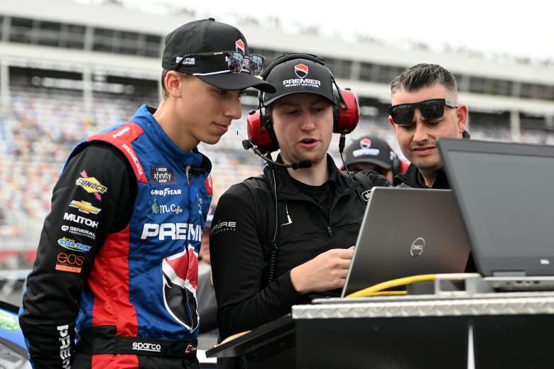 CONCORD, NORTH CAROLINA - MAY 26: Carson Hocevar, driver of the #77 Premier Security Chevrolet, looks over data with his team during qualifying for the NASCAR Xfinity Series Alsco Uniforms 300 at Charlotte Motor Speedway on May 26, 2023 in Concord, North Carolina. (Photo by Logan Riely/Getty Images)