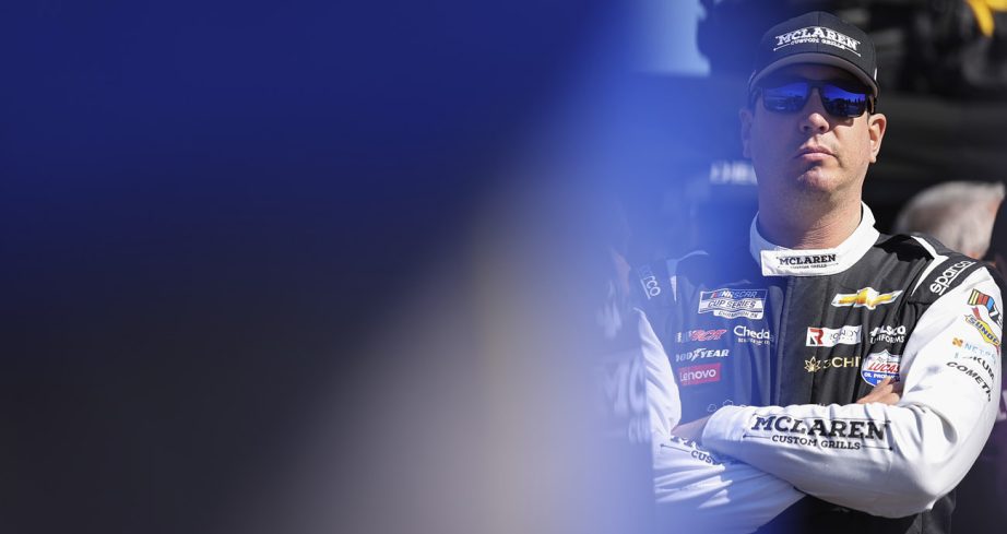Kyle Busch stands with his arms crossed.
