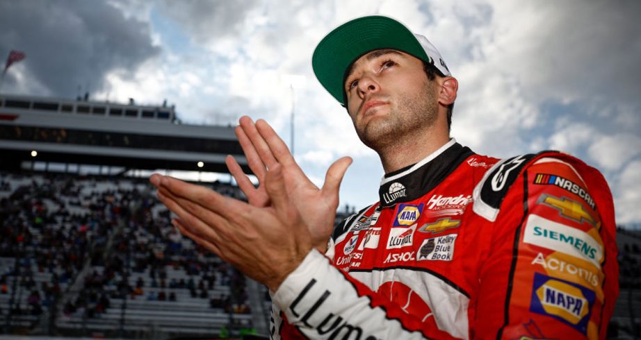 Chase Elliott claps after winning the pole at Martinsville in 2022.