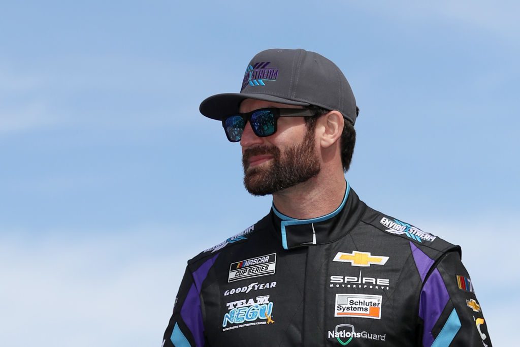 LAS VEGAS, NEVADA - MARCH 05: Corey LaJoie, driver of the #7 EnviroXstream Chevrolet, walks onstage during driver intros prior to the NASCAR Cup Series Pennzoil 400 at Las Vegas Motor Speedway on March 05, 2023 in Las Vegas, Nevada. (Photo by Meg Oliphant/Getty Images)