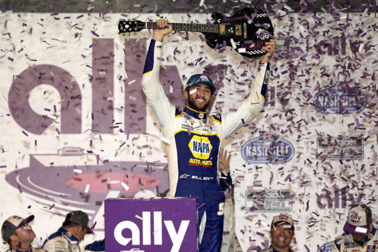 Chase Elliott celebrates Nashville win by raising guitar in Victory Lane.
