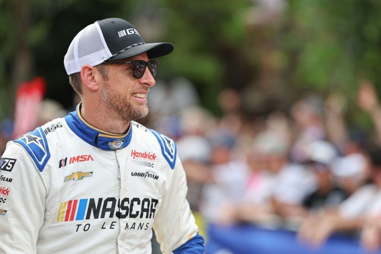 Jenson Button looks on.
