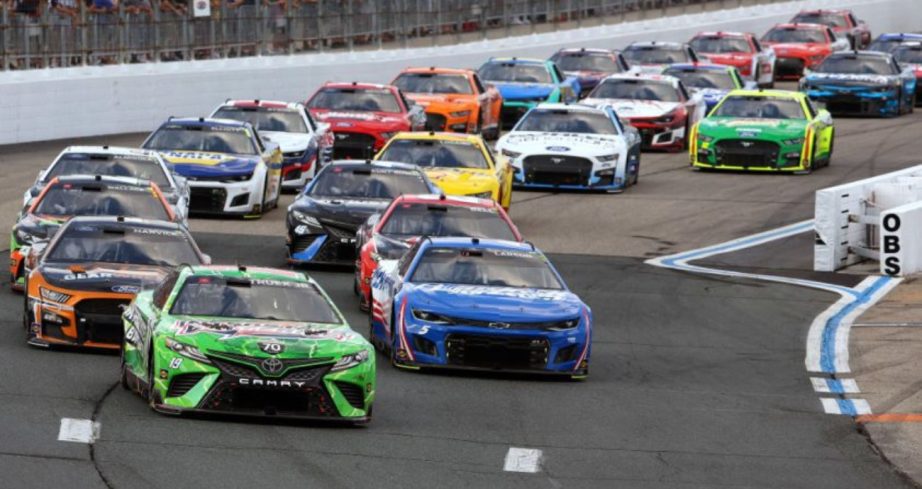 NASCAR Cup Series cars race around New Hampshire Motor Speedway.