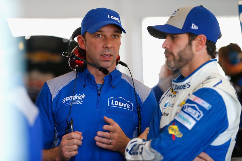 Chad Knaus, left, and Jimmie Johnson talk in the garage