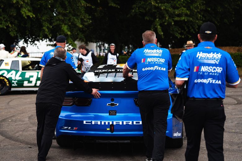 Team members push the Garage 56 entry at Goodwood Festival of Speed