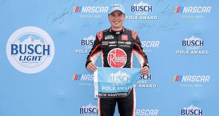 Christopher Bell holds the Busch Light Pole Award flag after topping the qualifying chart at New Hampshire Motor Speedway