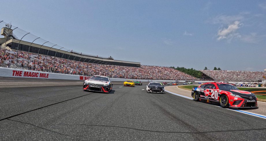 NASCAR Cup Series cars race at New Hampshire Motor Speedway.