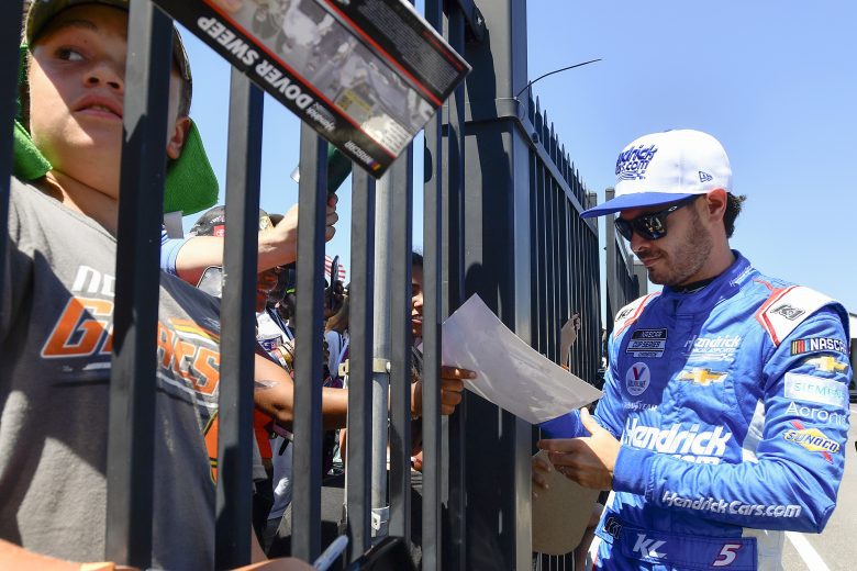 Kyle Larson signs an autograph for a fan at Pocono