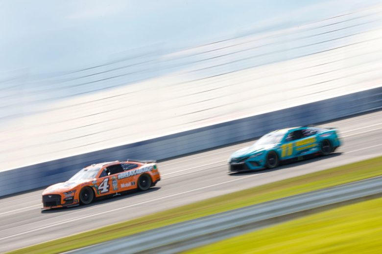Kevin Harvick and Denny Hamlin race at Pocono Raceway.
