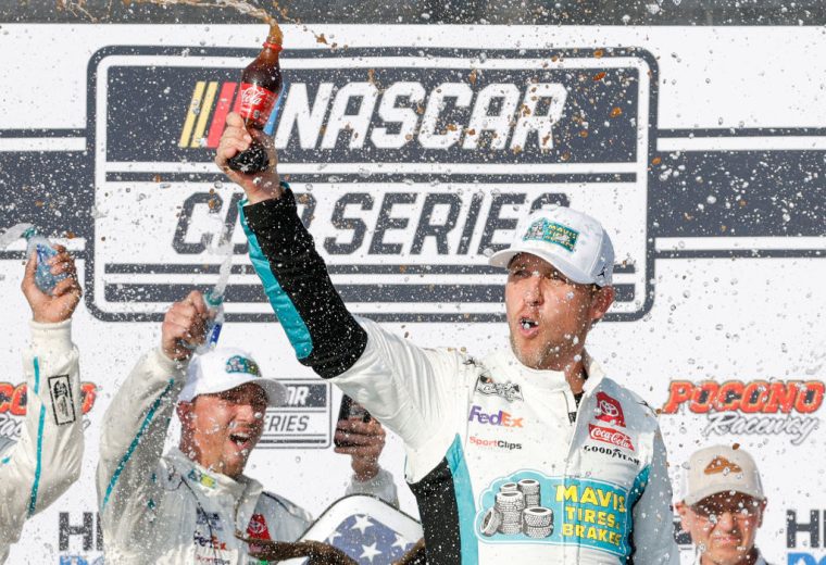 Denny Hamlin celebrates in Victory Lane at Pocono Raceway.
