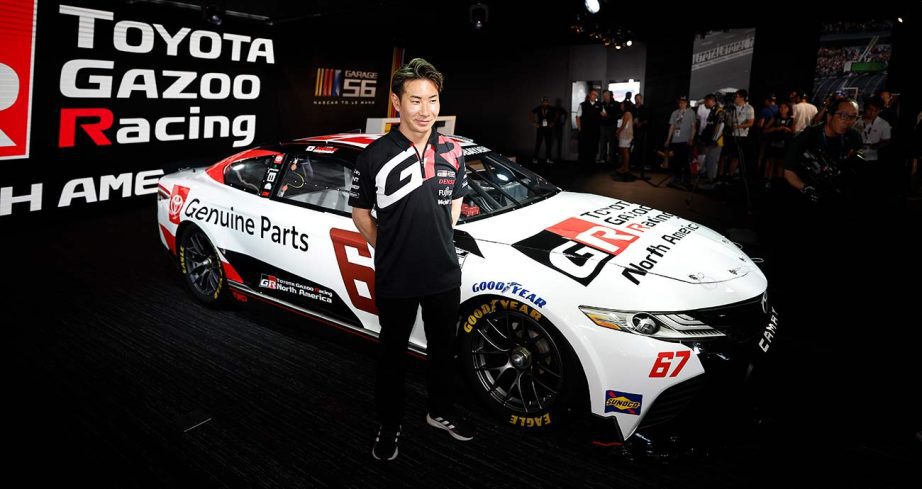 Kamui Kobayashi at the unveiling of his Cup Series effort at the NASCAR display at the 24 Hours of Le Mans