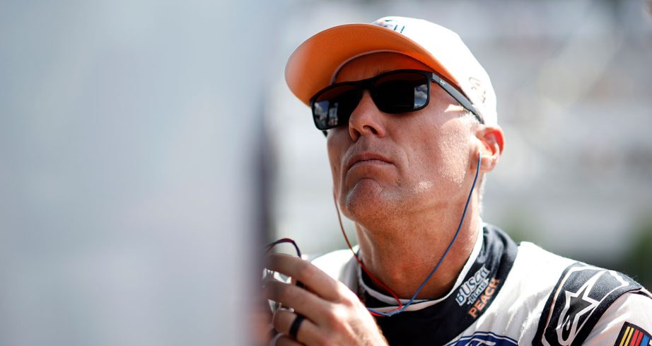 Kevin Harvick looks up while wearing sunglasses