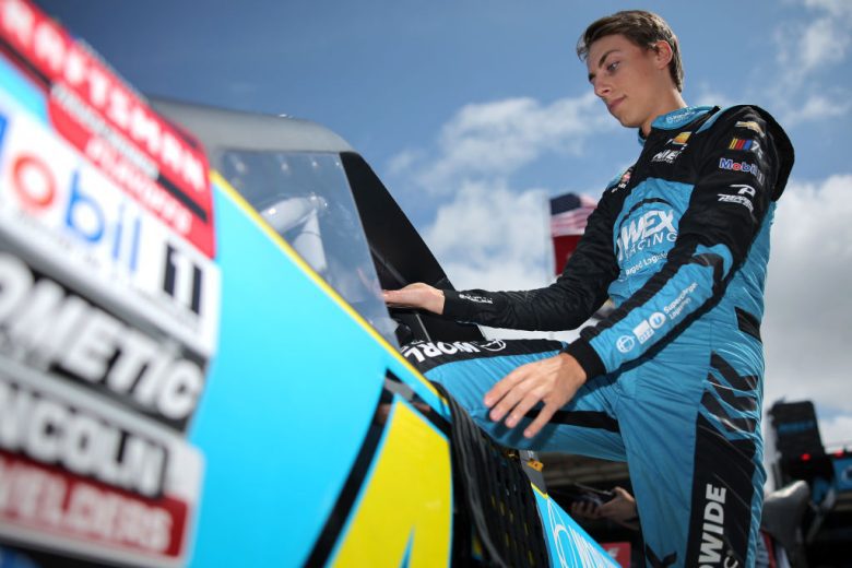Carson Hocevar climbs into his truck.