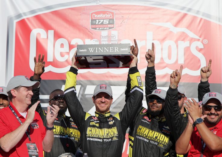 Grant Enfinger lifts the trophy after winning at Milwaukee