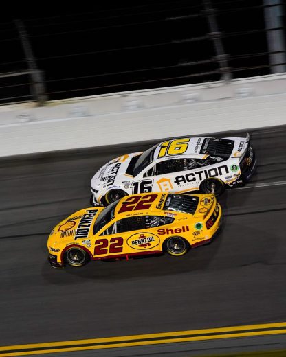 Joey Logano and AJ Allemdinger race at Daytona.