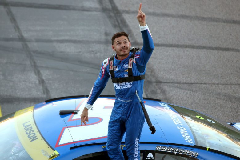 Kyle Larson stands atop his No. 5 Chevrolet.