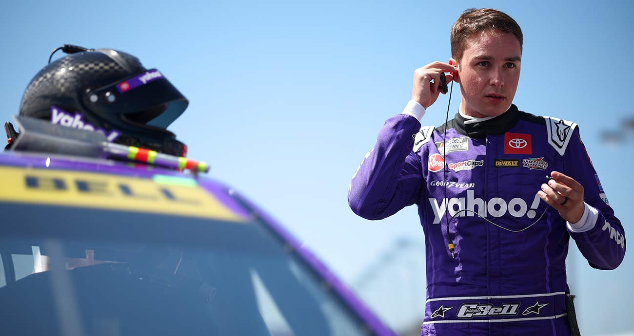 Christopher Bell suits up beside his No. 20 Toyota at Darlington Raceway