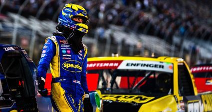 Zane Smith leans against his blue No. 38 truck while still wearing his helmet after a 24th-place finish at Bristol