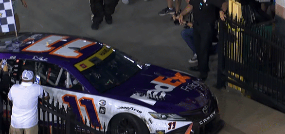 Denny Hamlin's car taps a fence on the way to Bristol Victory Lane