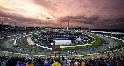 The Cup Series field races with a setting sun as the backdrop during NASCAR All-Star Race weekend at North Wilkesboro Speedway
