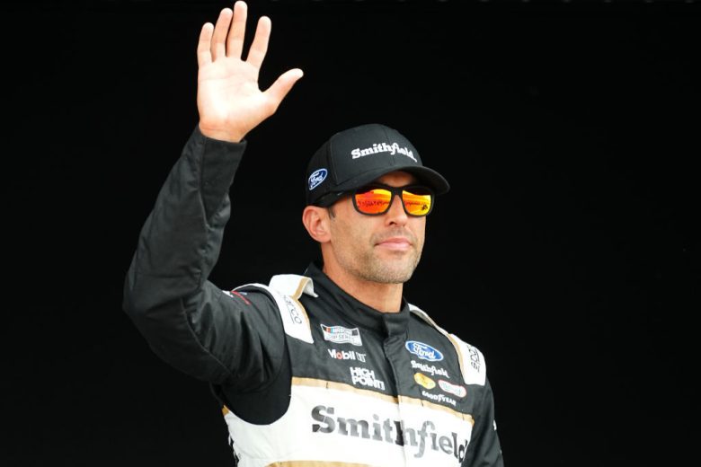 Aric Almirola waves to fans.