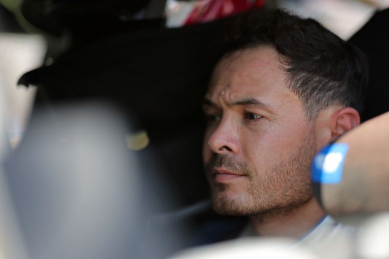 Kyle Larson looks on.