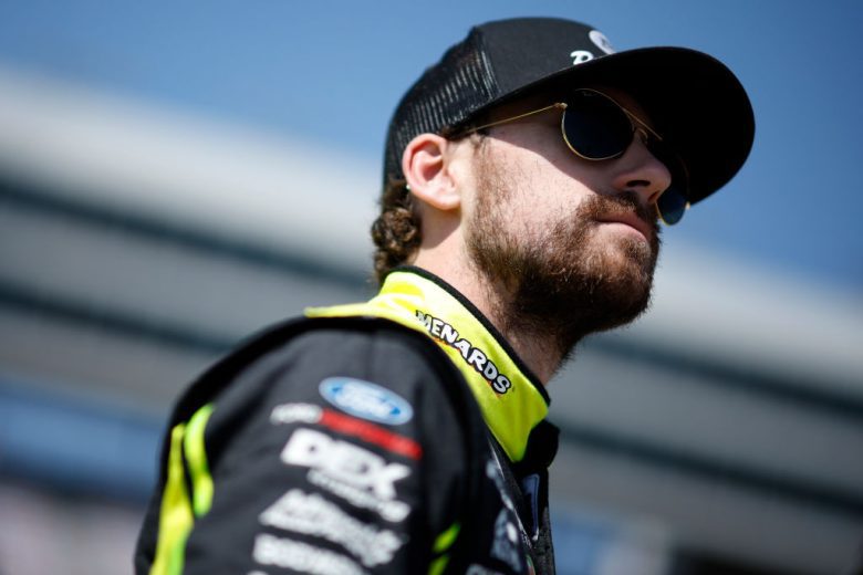 Ryan Blaney looks on.