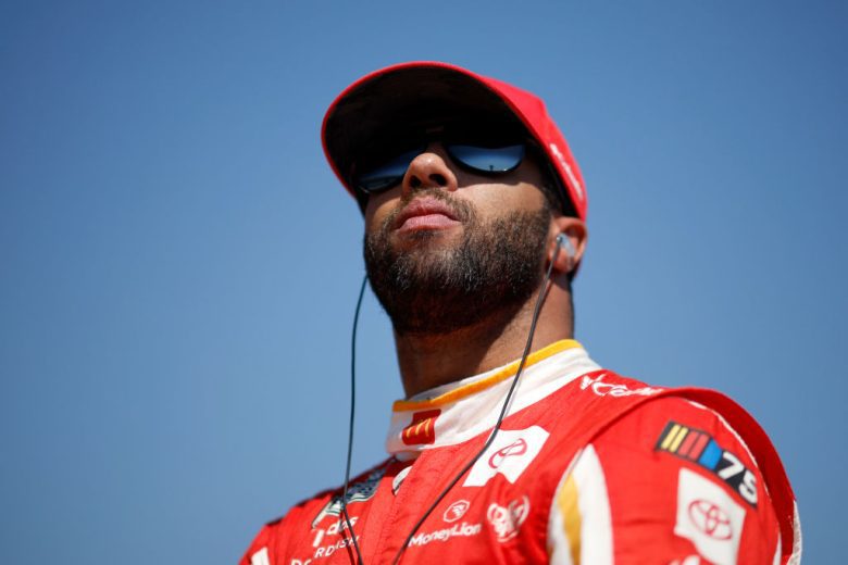 Bubba Wallace looks on.