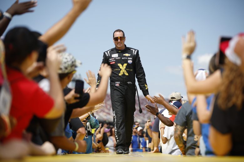 Kyle Busch high fiving fans.