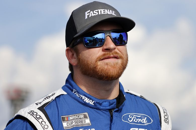 Chris Buescher smiles while wearing hat and sunglasses