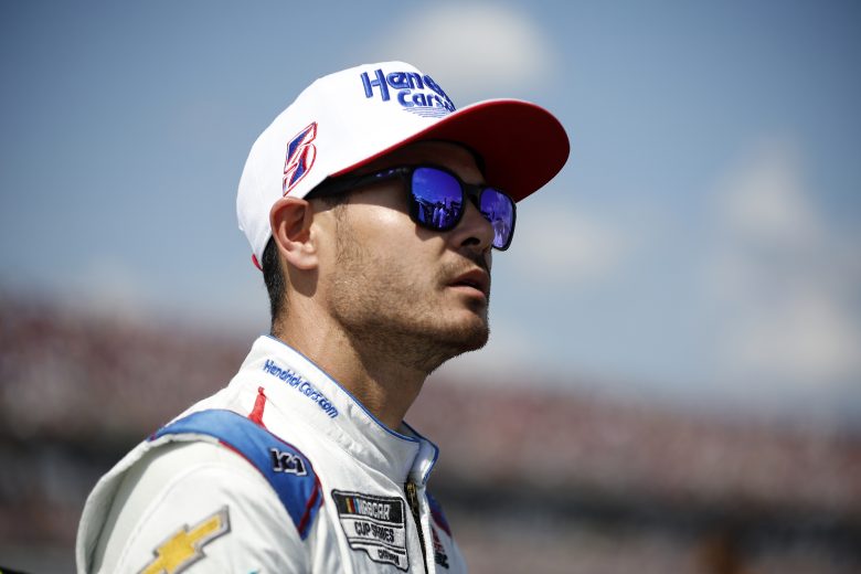 Kyle Larson in hat and sunglasses on pit road