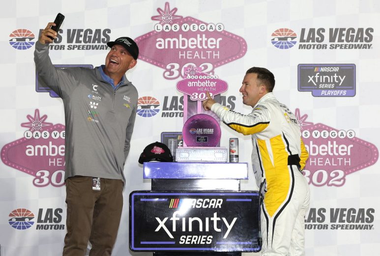 Chris Rice (L) takes a selfie with AJ Allmendinger (R) in Victory Lane at Las Vegas Motor Speedway.