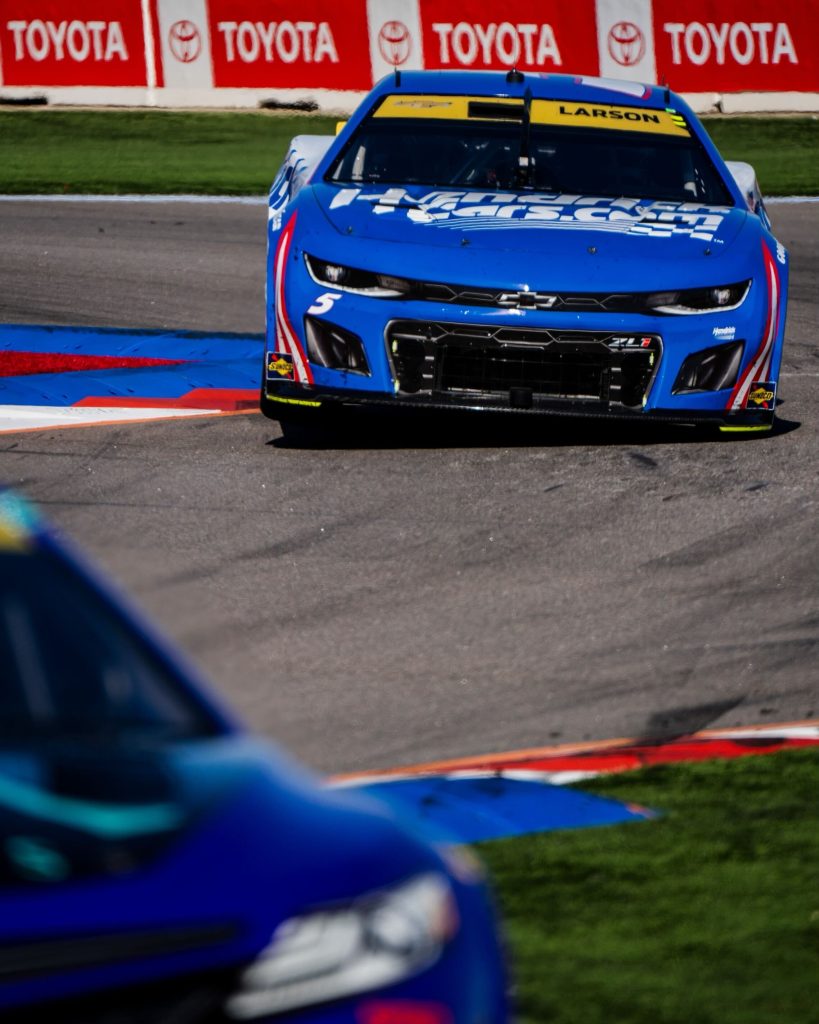 Kyle Larson rounds a corner over a curb at Charlotte Motor Speedway Roval