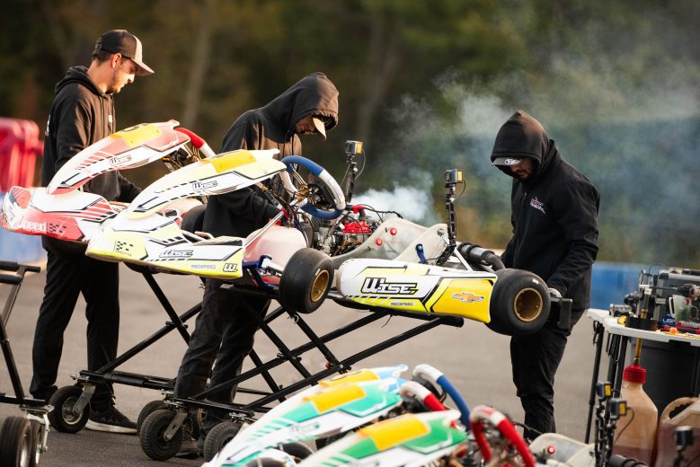 Crew members prepping karts before on track activity at Trackhouse Motorplex
