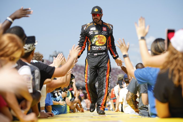 Martin Truex Jr. walks down stage and high fives fans.