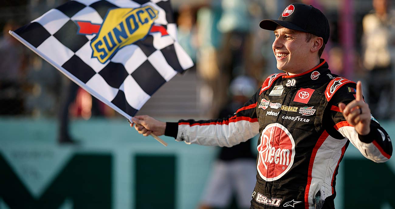 Christopher Bell with the checkered flag after his Cup Series win at Homestead-Miami Speedway