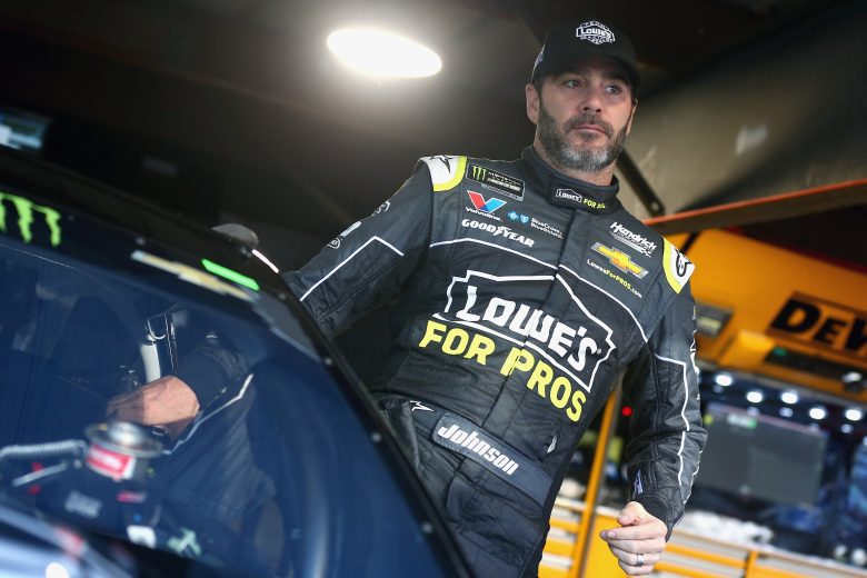 Jimmie Johnson climbs into cup series car.