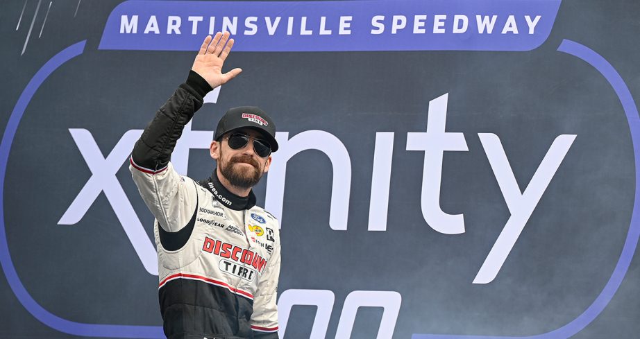 Ryan Blaney, driver of the No. 12 Discount Tire Ford, waves to fans as he walks onstage during driver intros prior to the NASCAR Cup Series Xfinity 500 at Martinsville Speedway.