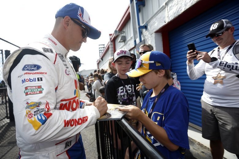 Ryan Preece signs autographs.