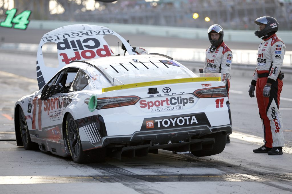 HOMESTEAD, FLORIDA - OCTOBER 22: Crew members of the #11 Sport Clips Haircuts Toyota, driven by Denny Hamlin react after a race ending on-track incident during the NASCAR Cup Series 4EVER 400 Presented by Mobil 1 at Homestead-Miami Speedway on October 22, 2023 in Homestead, Florida. (Photo by James Gilbert/Getty Images)