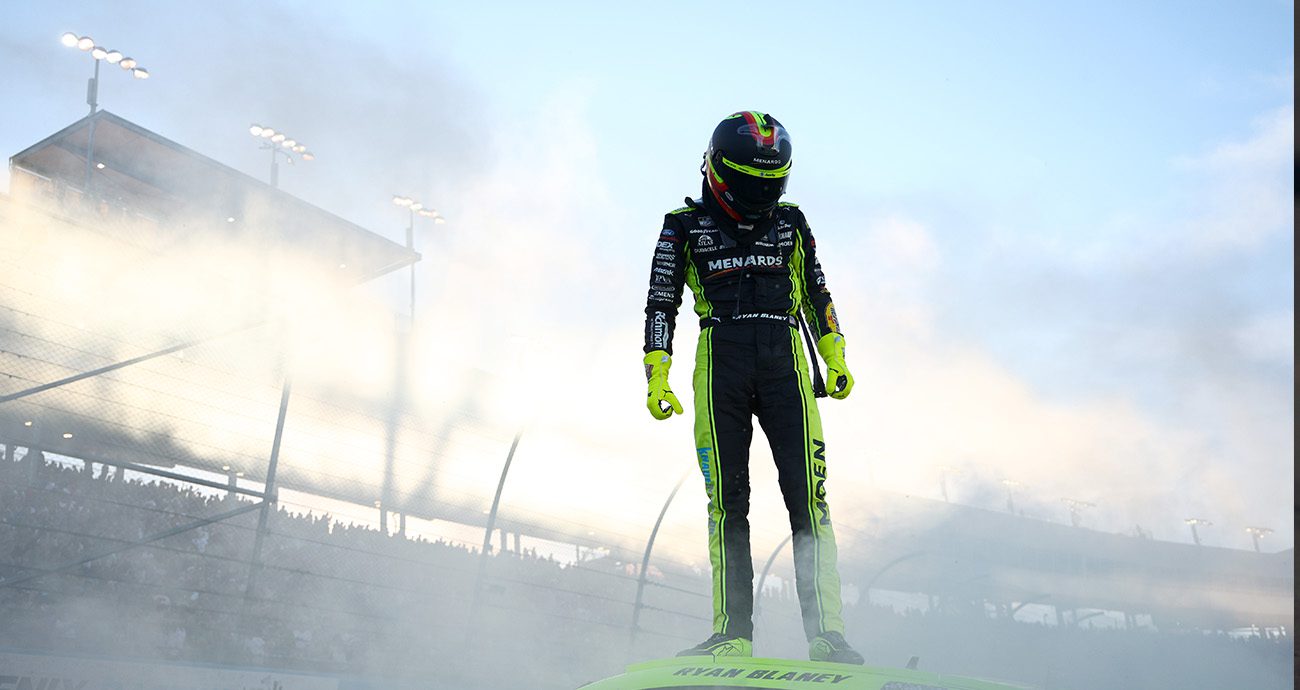 Ryan Blaney, driver of the No. 12 Menards/Dutch Boy Ford, celebrates with a burnout after winning the 2023 NASCAR Cup Series Championship at Phoenix Raceway.