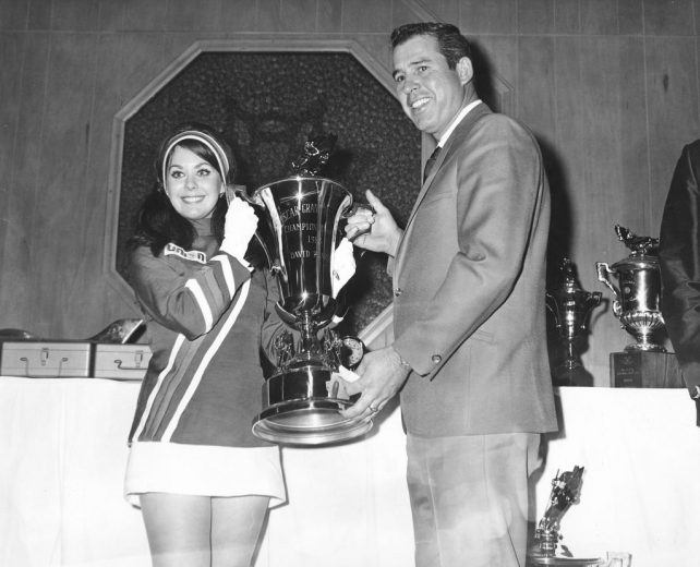 David Pearson holds up his championship trophy.