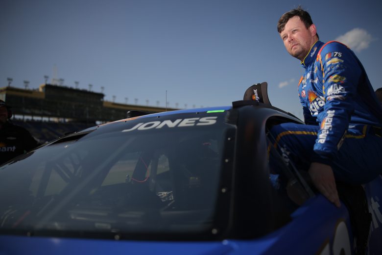 Erik Jones, driver of the #43 Allegiant Chevrolet, enters his car during qualifying for the NASCAR Cup Series Advent Health 400 at Kansas Speedway on May 06, 2023 in Kansas City, Kansas.