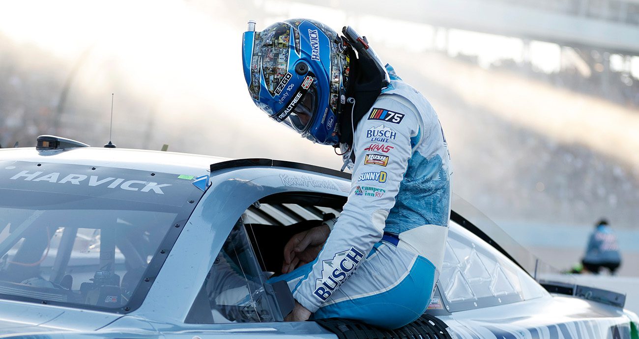 Kevin Harvick climbs out of his car on pit road at Phoenix Raceway.