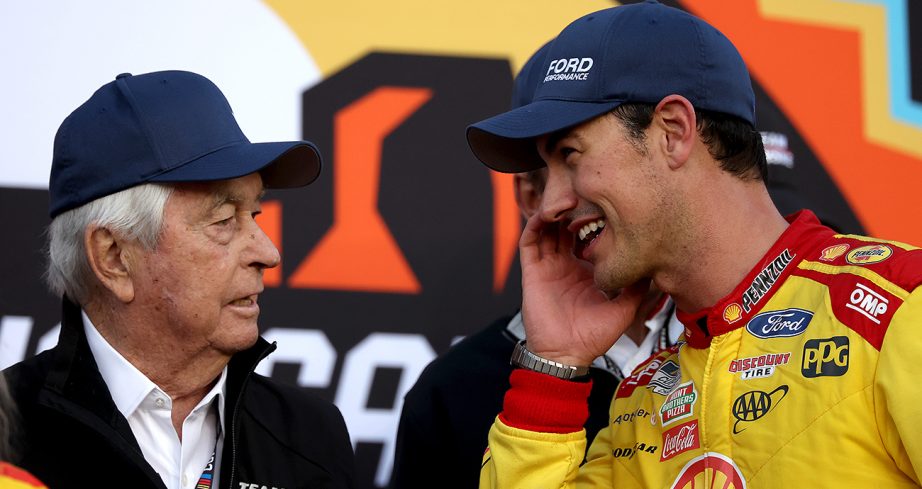 Roger Penske talks with Joey Logano in Victory Lane.