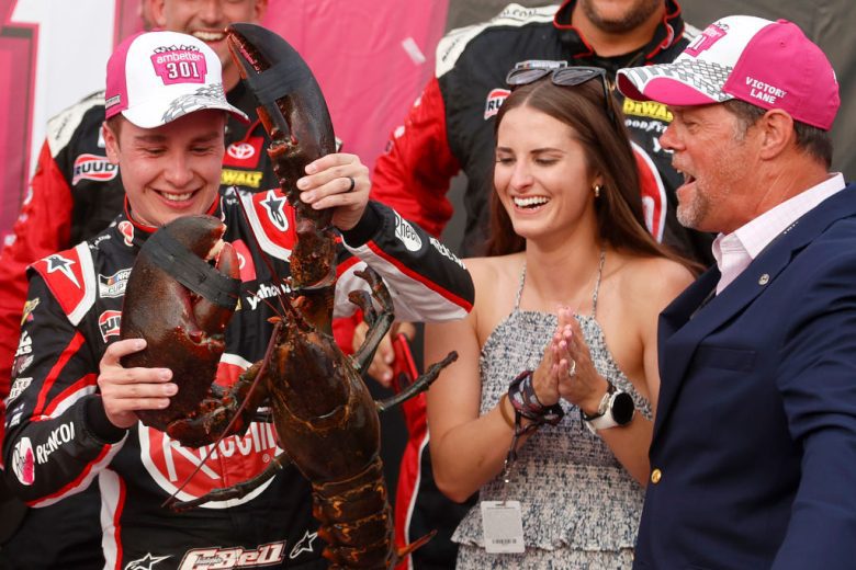Christopher Bell hold lobster in Victory Lane at New Hampshire Motor Speedway.