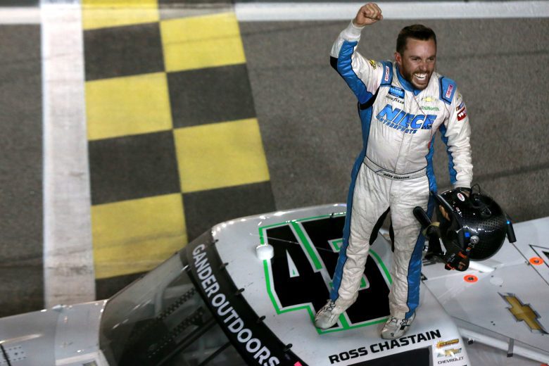 Ross Chastain stands on top of truck celebrating win